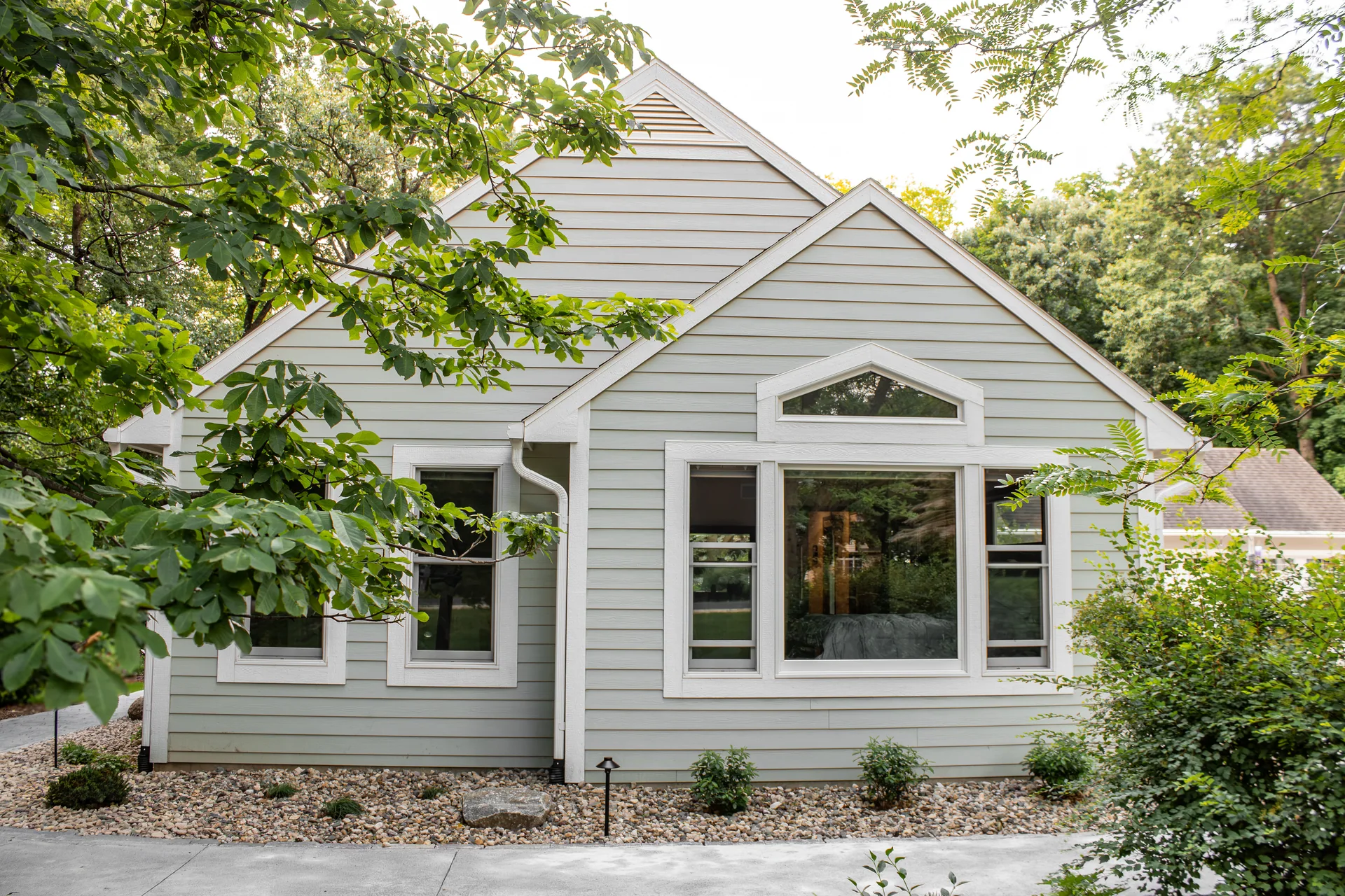 Gabled addition with a picture window and upper transom
