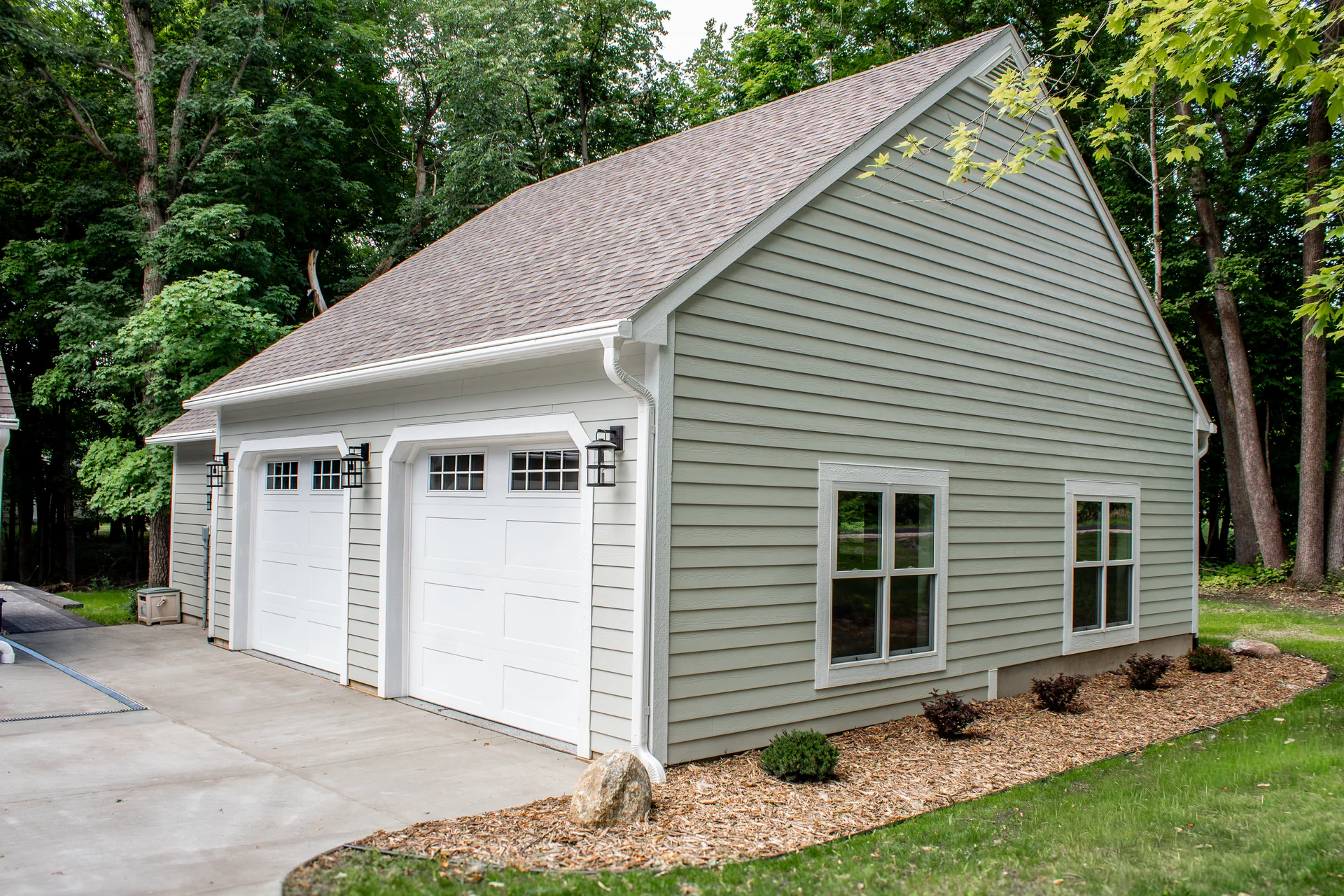 Detached garage and shop exterior with two overhead doors