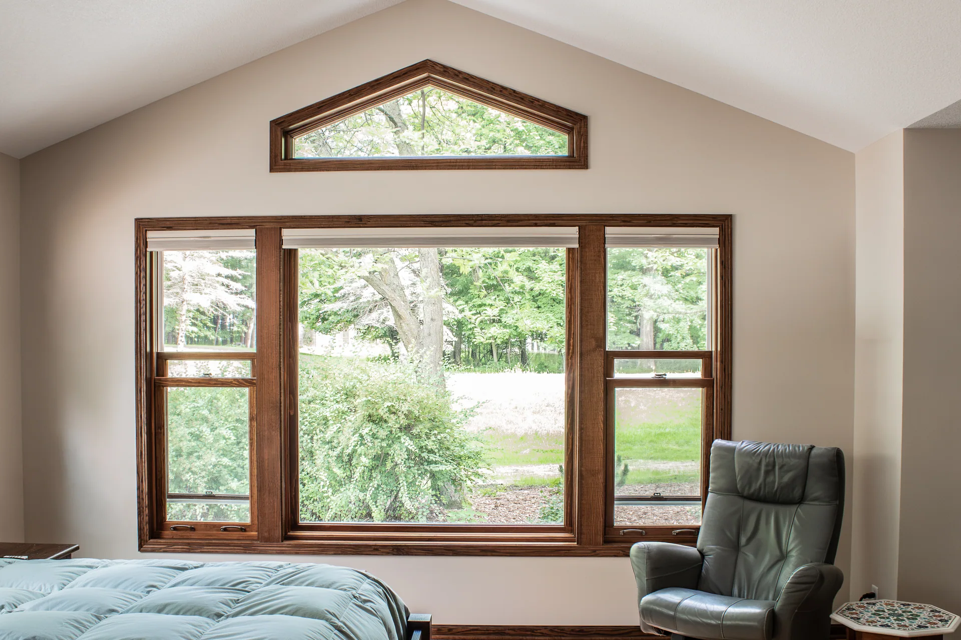 Primary bedroom picture window and gabled ceiling