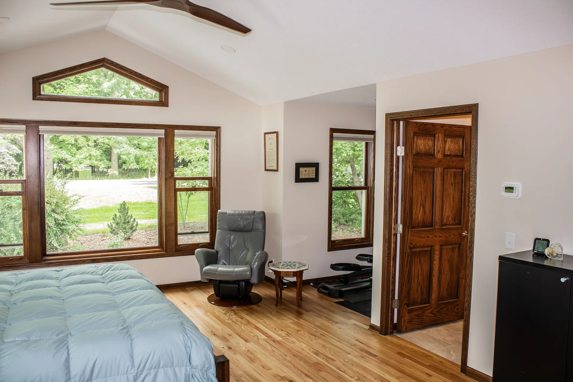 Primary bedroom with wood trim and views outdoors