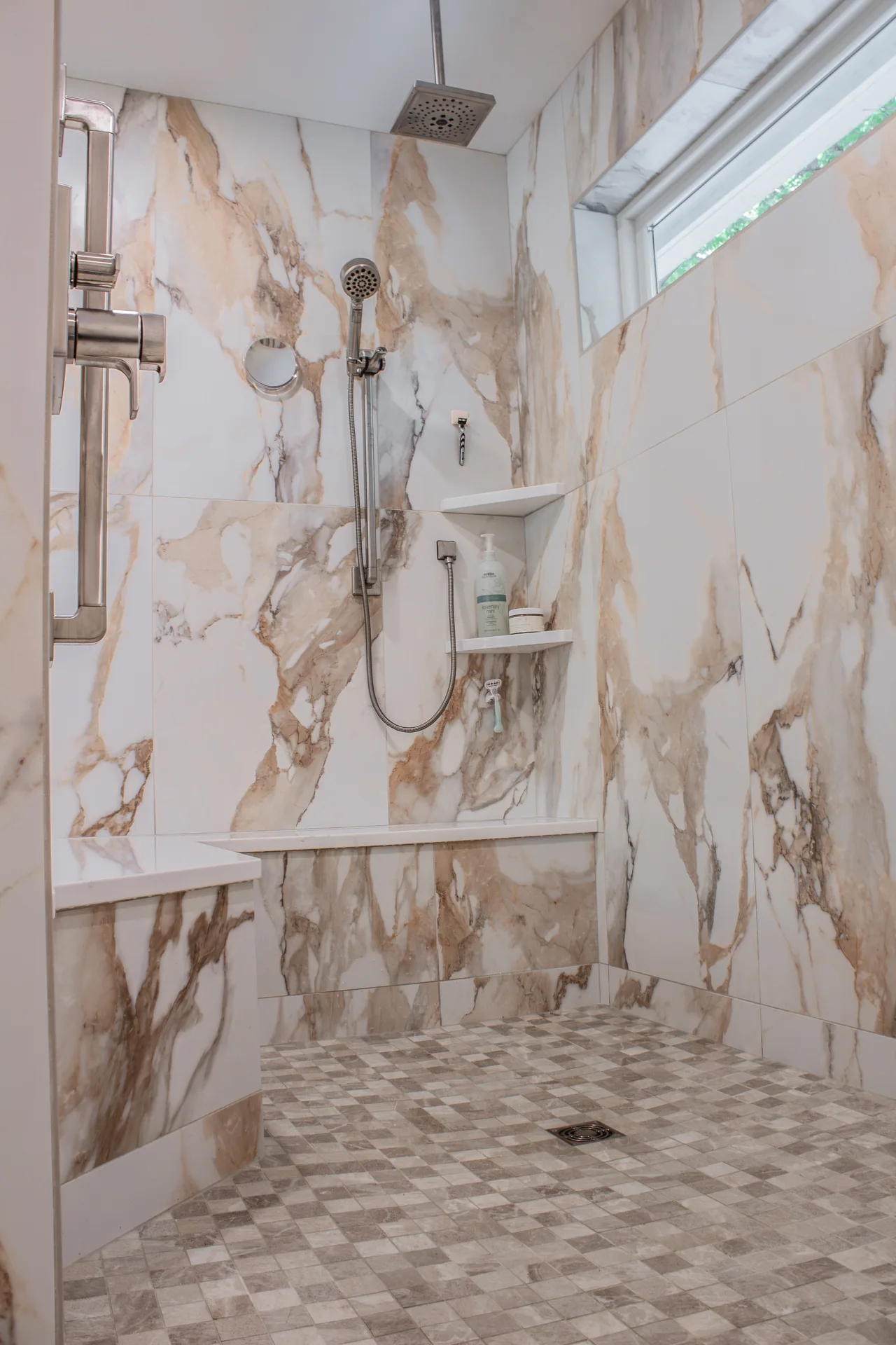 Walk-in shower with wall tile and pebble-pattern floor