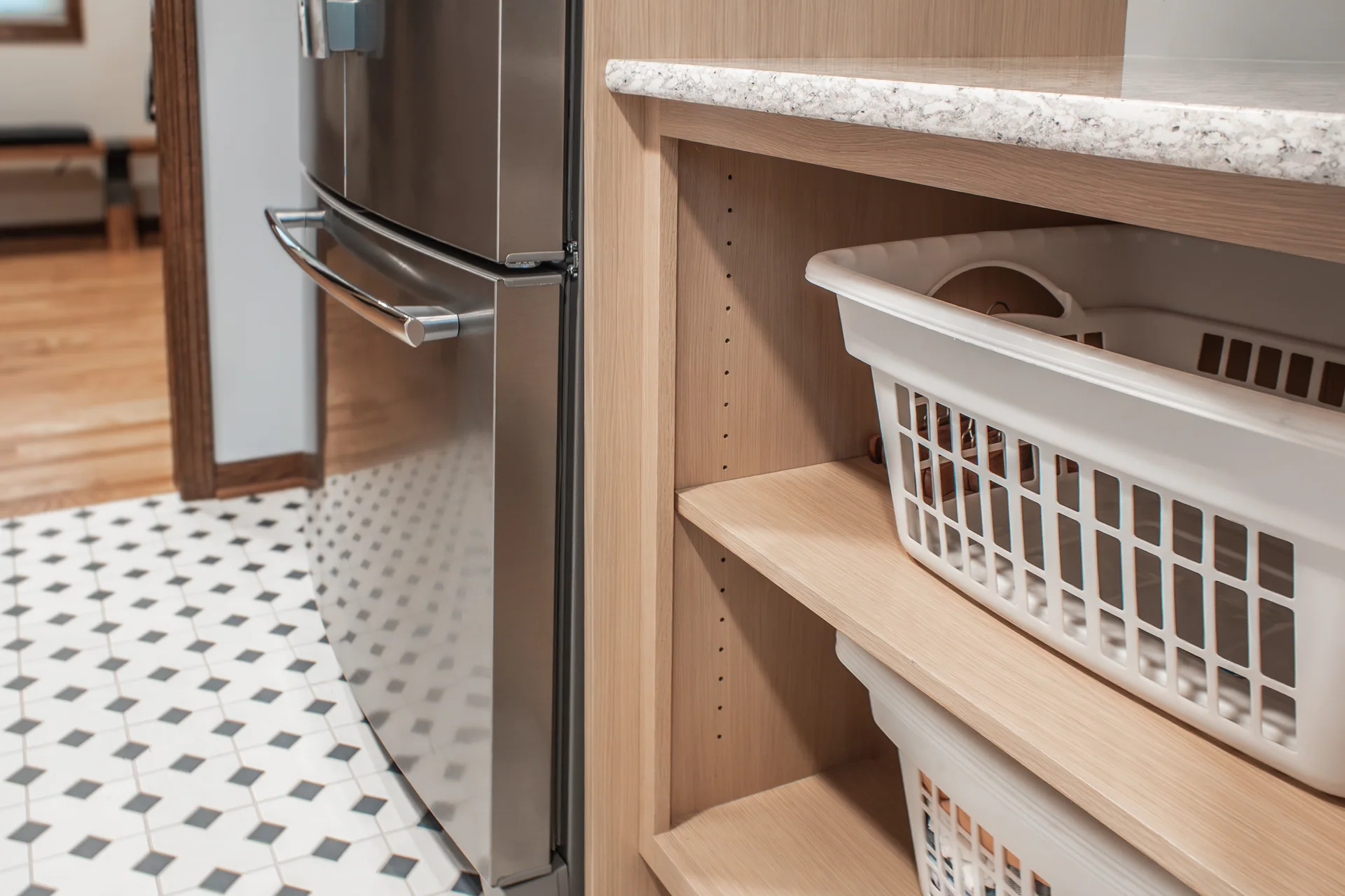 Pull-out laundry basket storage beneath the counter
