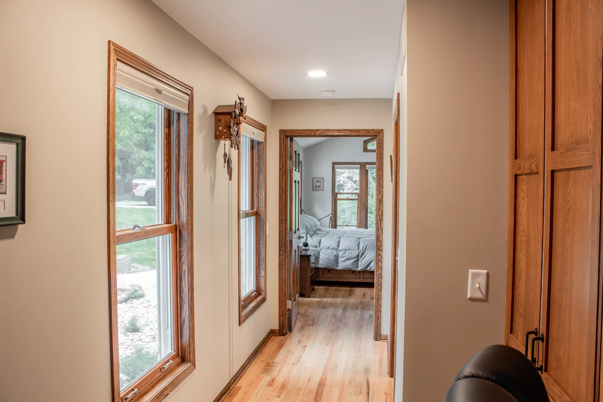 Wood-trimmed hallway leading to the primary bedroom