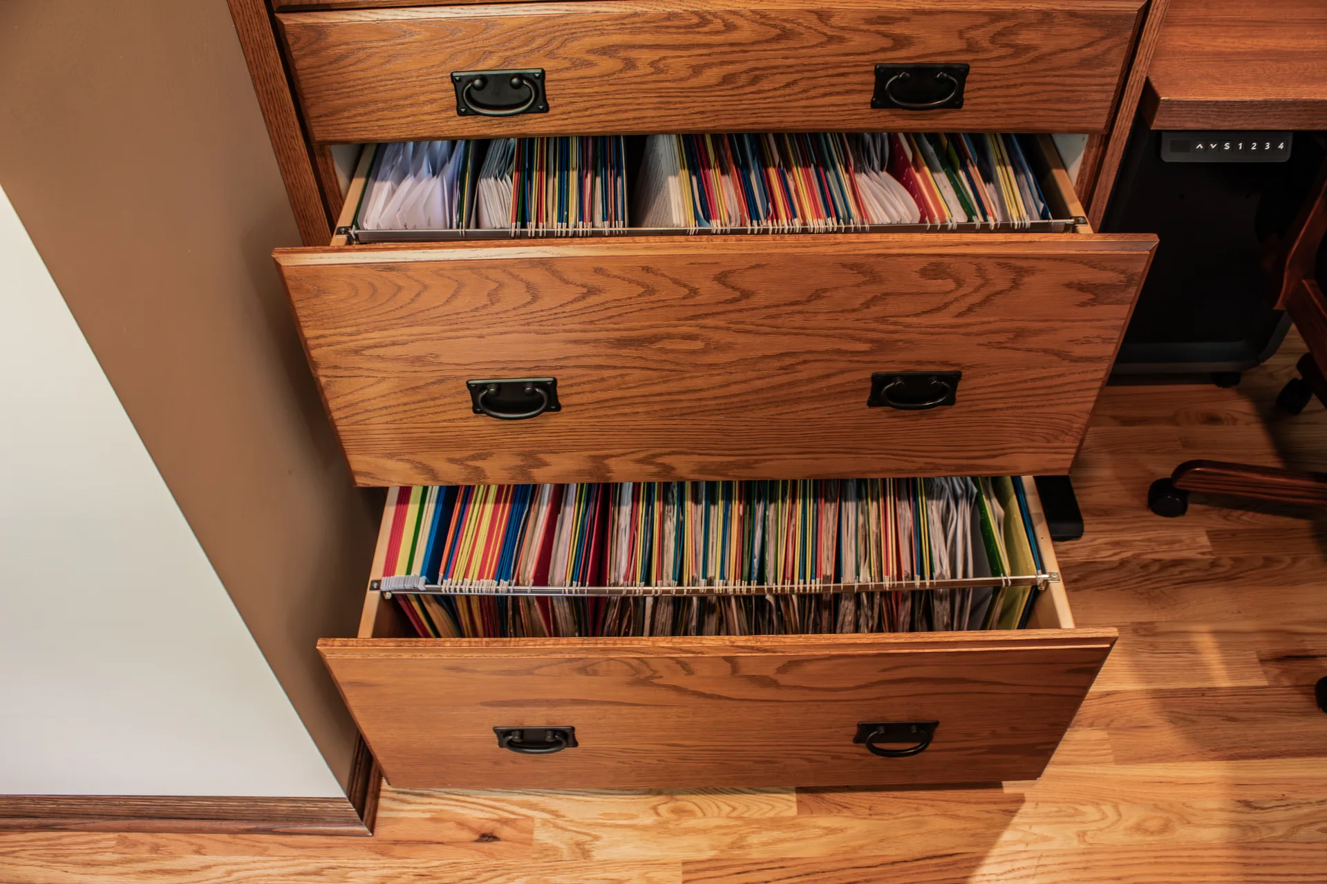 Pull-out file drawers in wood storage cabinetry